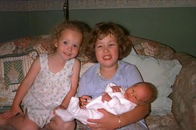 Hannah holding Amelia with Emilys help 12 Dec 1997.jpg